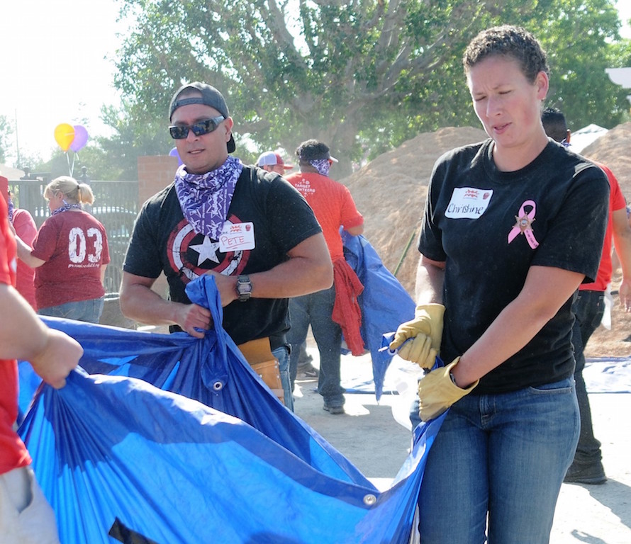 OCSD Dep. Pete Chavez and CSA Christine Smith hauled wood chips to the new playground, built by hundreds of volunteers at the Independencia Family Resource Center in Anaheim. Photo by Lou Ponsi/Behind the Badge OC 