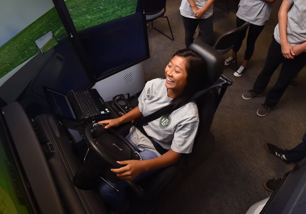 Maggie Lin tries her hand at the police driving simulator at the Orange County Sheriff's Training Center. Photo by Steven Georges/Behind the Badge OC