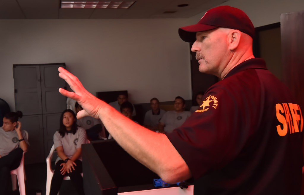 Sgt. Richard Nelson of the OC Sheriff’s Department instructs a group of kids from the Youth Citizens’ Academy before giving them their turn with the shoot or don’t shoot simulator at the Orange County Sheriff's Training Center. Photo by Steven Georges/Behind the Badge OC