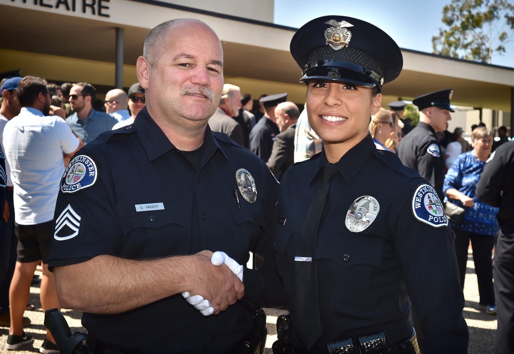 On his last day before retiring, Westminster PD Sgt. Darrick Vincent, left, congratulates Frani Echavarria after graduation from the Golden West College Criminal Justice Training Center Basic Police Academy, Class of 152. Photo by Steven Georges/Behind the Badge OC