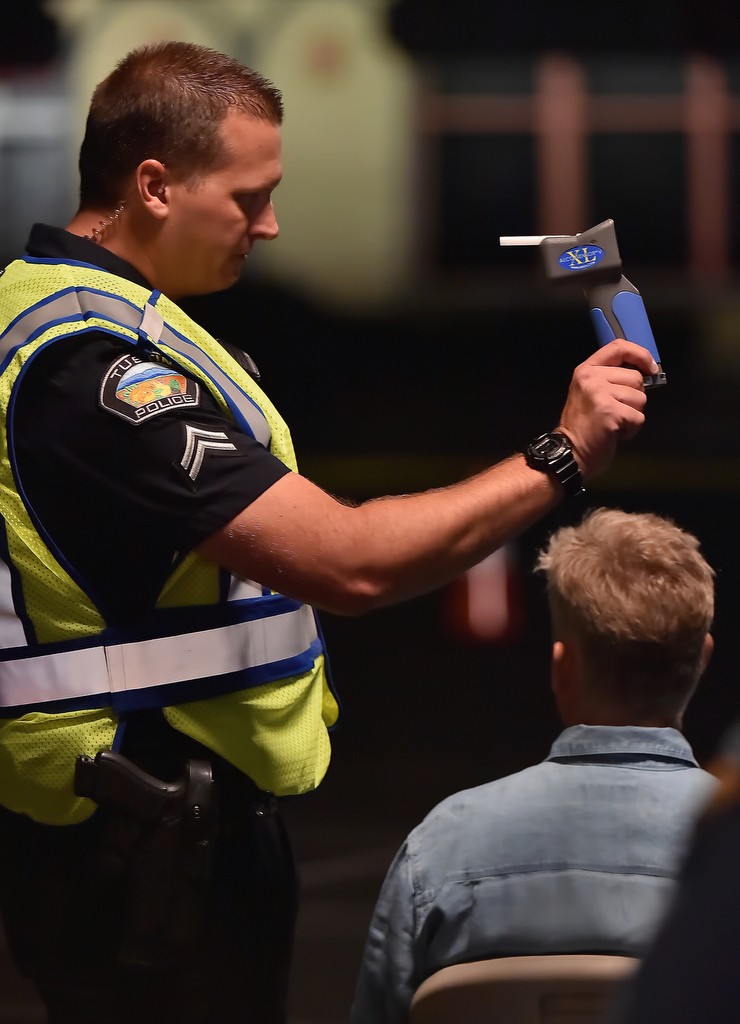 Tustin PD Drug Recognition Expert Jeremy Laurich shows the results of a DUI breathalyzer to another officer. The driver was able to pass the test and was allowed to drive home on his own. Photo by Steven Georges/Behind the Badge OC