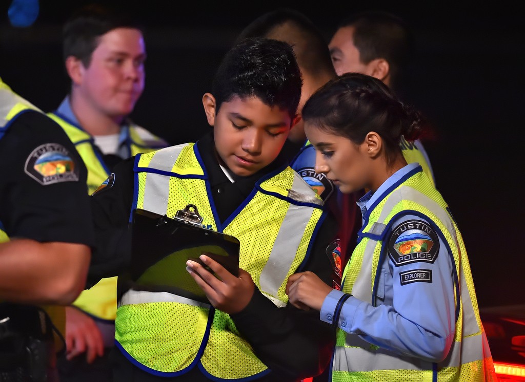 Tustin PD Explorers Jaime Sandoval and Getzemany Falgado, right, look over the records they take down during a DUI checkpoint. Photo by Steven Georges/Behind the Badge OC