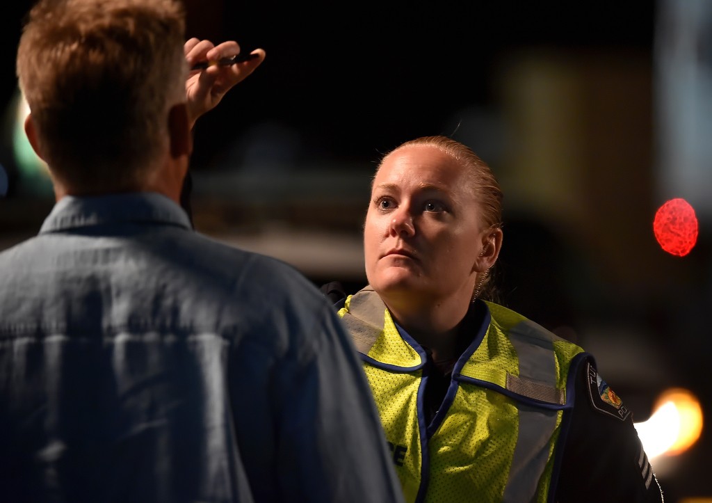 Tustin PD Sgt. Sara Fetterling, a Drug Recognition Expert, runs a driver through a set of tests after being pulled over at a DUI checkpoint. The driver was able to pass the test and was allowed to drive away on his own. Photo by Steven Georges/Behind the Badge OC