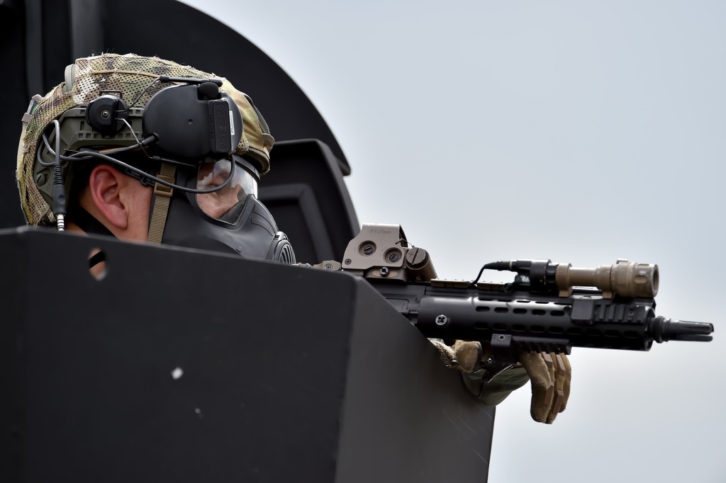 A North County SWAT officer covers the other officers from the turret of a BearCat (SWAT vehicle) during SWAT drills in Irvine. Photo by Steven Georges/Behind the Badge OC