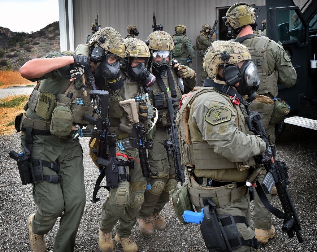North County SWAT members remove a simulated wounded officer, Placentia Officer Joe Gillis, from the line of fire and to the medics during a drill. Photo by Steven Georges/Behind the Badge OC