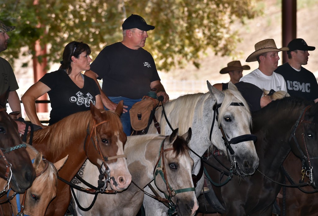 Clyde, a rescued Percheron horse now serving with the OC Sheriff Department with Lt. Doug Williams, center, trains with other mounted unit law enforcement horses at the George Ingalls Equestrian Event Center in Norco. Photo by Steven Georges/Behind the Badge OC