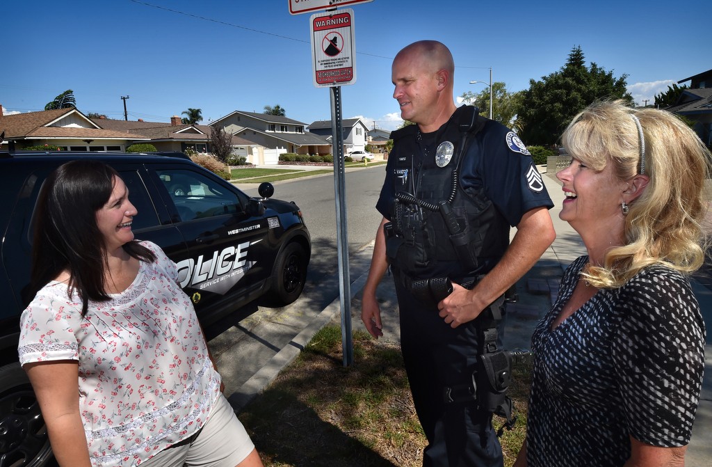 Westminster PD Sgt. Cord Vandergrift talks to Neighborhood Watch organizers Missi Hernandez, left, and Cheryl Acoutin about the concerns of the neighborhood. Photo by Steven Georges/Behind the Badge OC