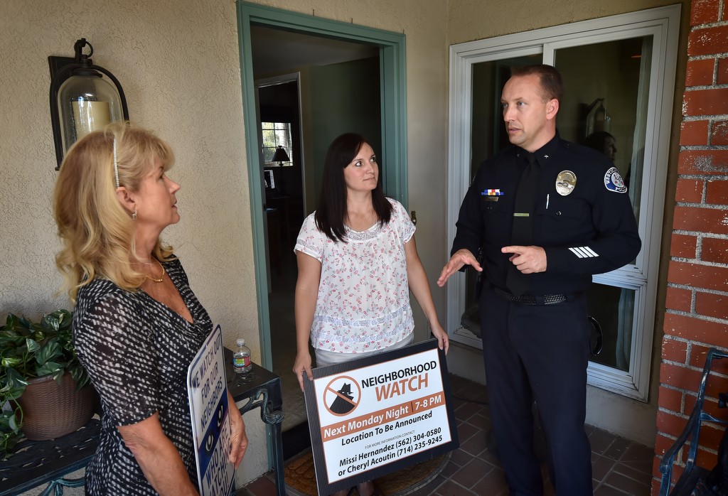 Westminster PD Cmdr. Cameron Knauerhaze visits Cheryl Acoutin, left, and Missi Hernandez of the Sol Vista Neighborhood Watch organization after they were able to raise money and install surveillance cameras on neighborhood streets to help keep the area safe and deter break-ins. Photo by Steven Georges/Behind the Badge OC