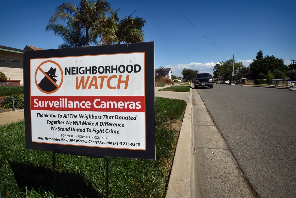 Signs on the street inform visitors the Sol Vista neighborhood is equipped with surveillance cameras and neighbors are watching.  Photo by Steven Georges/Behind the Badge OC