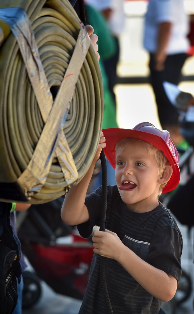 Mason Faulkner, 7 of Riverside, uses a pulley to lift a firehose during the Fire Service Day 2016 at the North Net North Net Fire Training Center in Anaheim. Photo by Steven Georges/Behind the Badge OC
