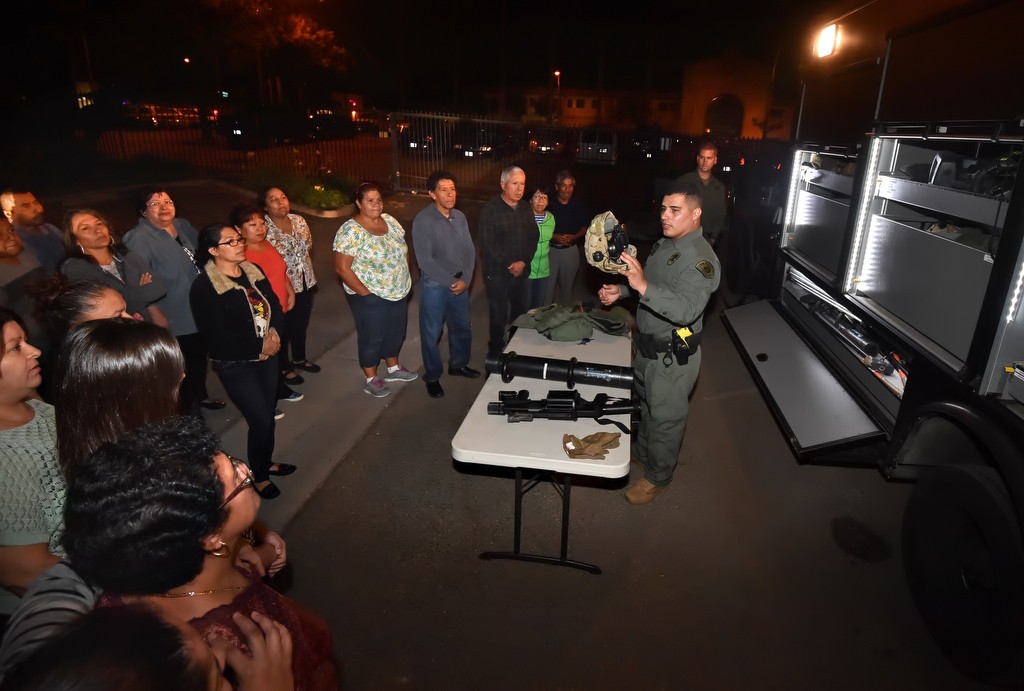 La Habra PD Officer Ricardo Rodriguez shows a Spanish speaking Citizens' Academy class various items used by the SWAT team. Photo by Steven Georges/Behind the Badge OC