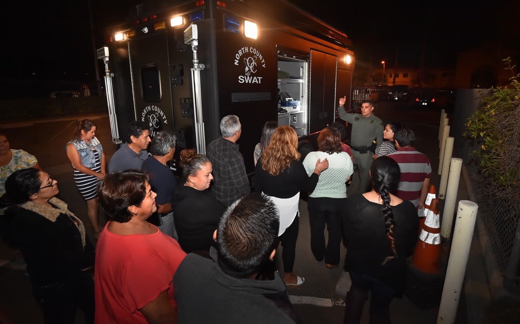 La Habra PD Officer Ricardo Rodriguez shows a Spanish speaking Citizens' Academy class items stored in a North County SWAT truck. Photo by Steven Georges/Behind the Badge OC