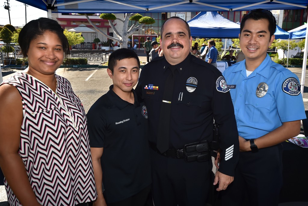 Andrea Grimes of American Family Housing Interns, left, Michael Son, housing administrative analyst for the City of Westminster, Westminster PD Cmdr. Mike Chapman and Billy Le, community liaison with the Westminster PD, at the Viet-CARE Pho-Covery Celebration in front of the Asian Garden Mall in Westminster. Photo by Steven Georges/Behind the Badge OC