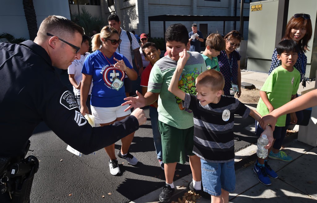 Fullerton PD Sgt. Jon Radus receives high-fives and fist bumps from Golden Hill Elementary School kids at the conclusion of a tour of the police station. Photo by Steven Georges/Behind the Badge OC