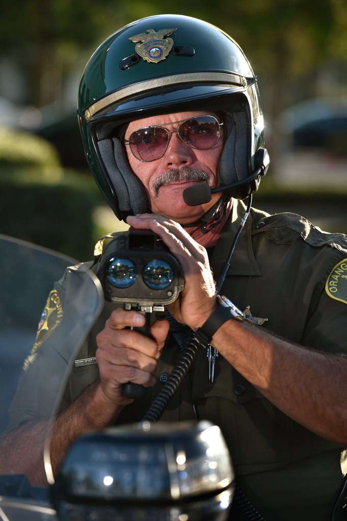 OC Sheriff Department Motor Dep. Greg Allen shows the radar gun he uses. Photo by Steven Georges/Behind the Badge OC