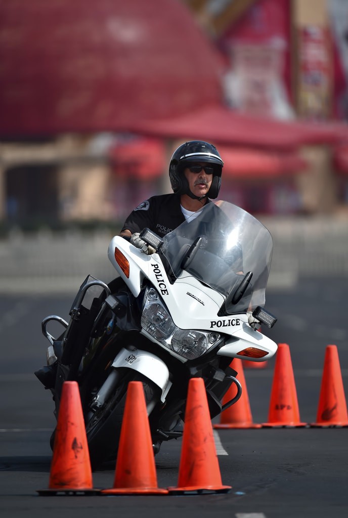 Officer Tony Silvestri makes his way through the 30 Cone Weave during Anaheim PD’s motor school in the parking lot of Angels Stadium. Photo by Steven Georges/Behind the Badge OC