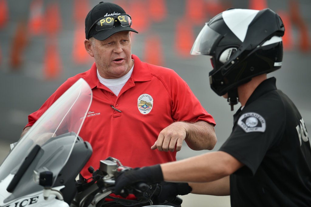 Anaheim PD Motor Instructor Doug Elms gives advice to Anaheim Sgt. Rick Boyer on how to run through the Incline Pullout course during Anaheim PD’s motorcycle school. Photo by Steven Georges/Behind the Badge OC