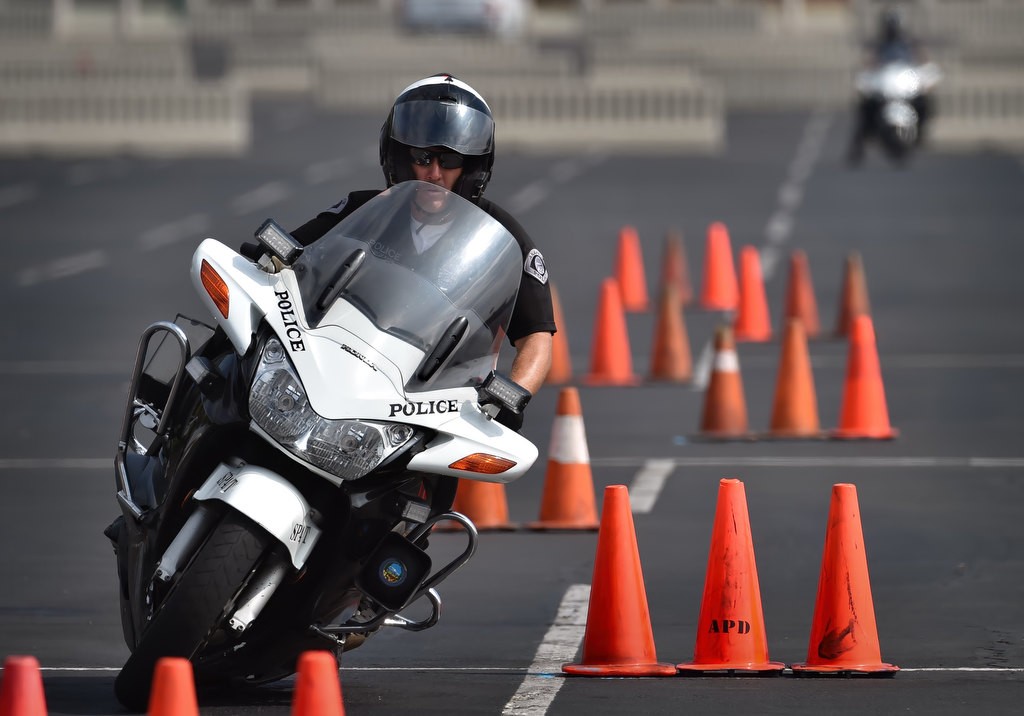 Anaheim PD Sgt. Rick Boyer cuts back and forth through the 30 Cone Weave, part of Anaheim PD’s motor school. Photo by Steven Georges/Behind the Badge OC