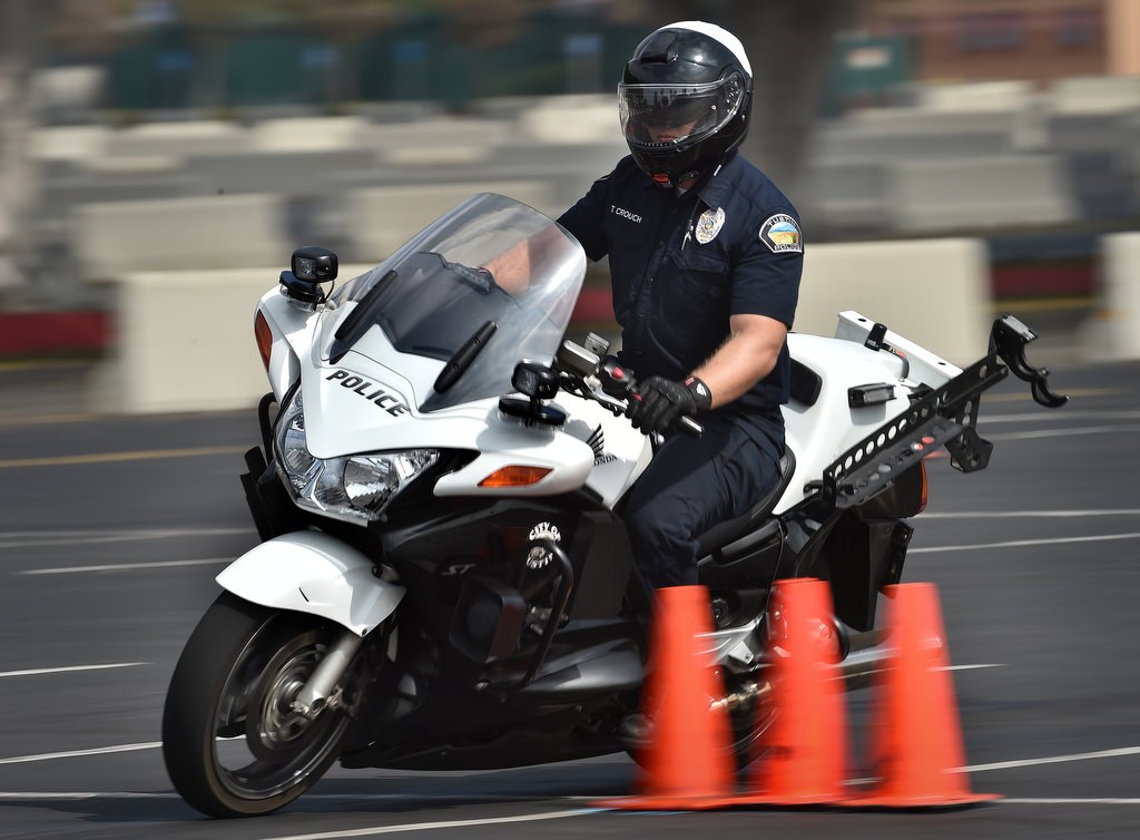 Tustin PD Officer Tim Crouch cuts back and forth through the 30 Cone Weave, part of Anaheim PDÕs motor school. Photo by Steven Georges/Behind the Badge OC