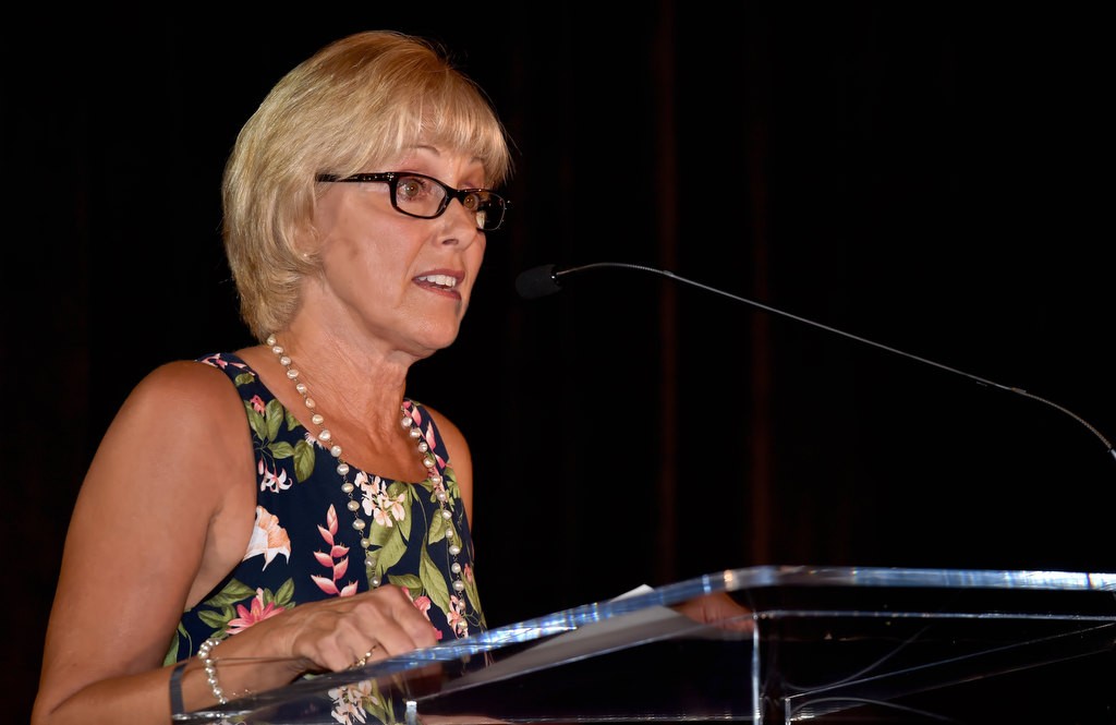 Susan Bruegman, board chairperson for the Orange County Family Justice Center Foundation, welcomes guest to A Celebration Of Strength dinner fundraiser. Photo by Steven Georges/Behind the Badge OC
