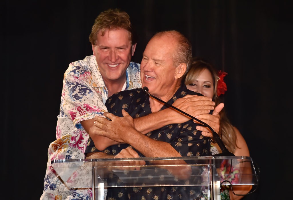 John Welter, former former Anaheim Police Chief, gets a playful hug from Patrick Mahoney, left, during the OCFJC Foundation’s fundraiser. Photo by Steven Georges/Behind the Badge OC