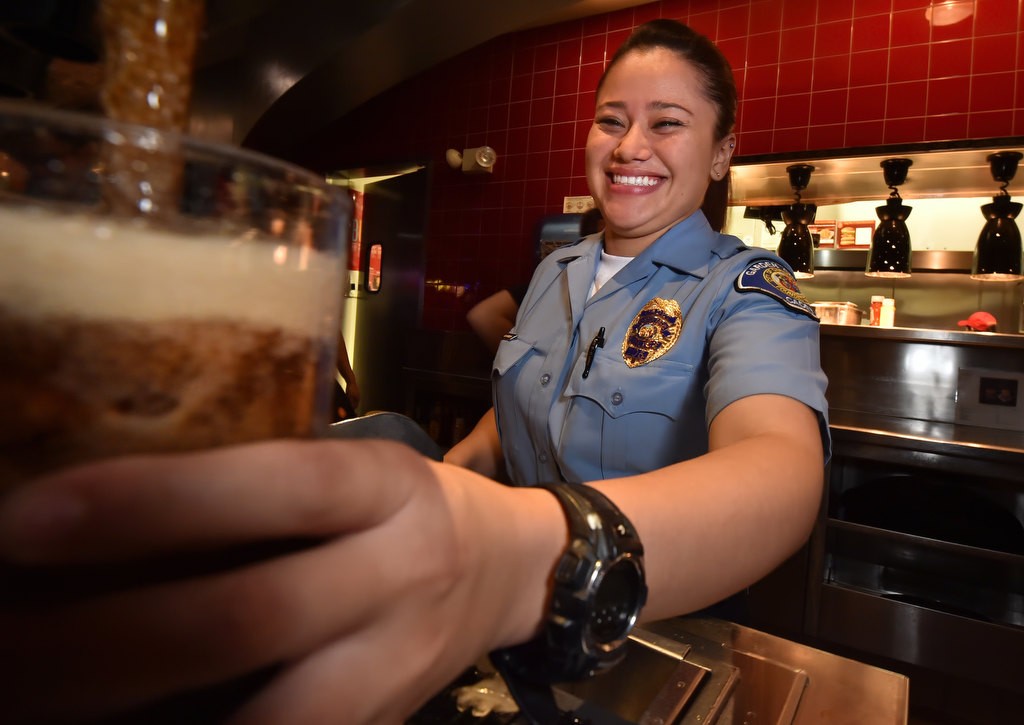 Garden Grove PD Cadet Michele Estrada gets a soda ready to serve during a Tip a Cop charity fundraiser for Special Olympics at a Red Robin restaurant in Garden Grove. Photo by Steven Georges/Behind the Badge OC