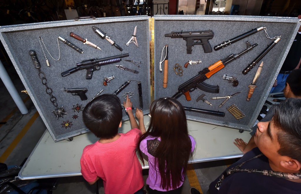 Kids check out various weapons confiscated by police during La Habra PD’s open house. Photo by Steven Georges/Behind the Badge OC