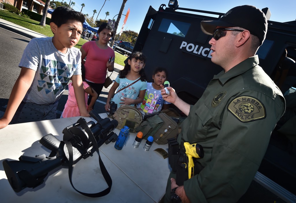 La Habra PD’s SWAT  member Nate Garcia describes the use of a less lethal weapon during La Habra PD’s open house. Photo by Steven Georges/Behind the Badge OC