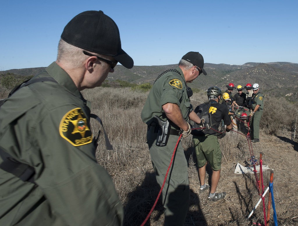Members of the Orange County Sheriff's Search and Rescue Team show the process of a medium angle extraction by pulling a litter from the brush in a demonstration of finding a lost subject in the Aliso Woods Wilderness Park.