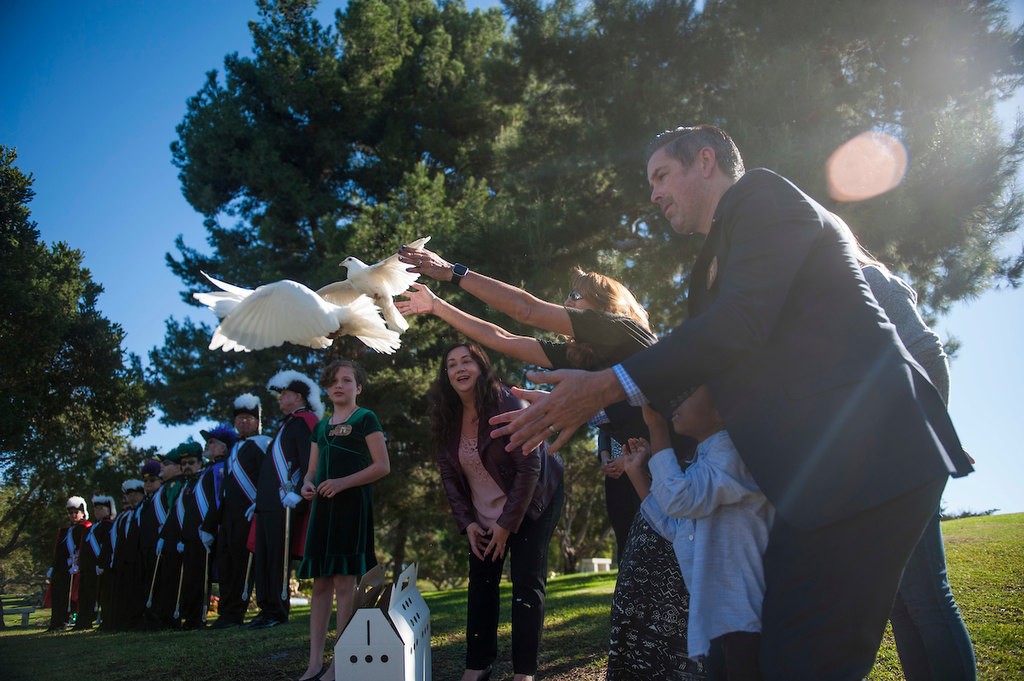 Volunteers for the Garden of Innocence Project release doves symbolizing the previous three infants buried at the Garden of Innocence at the El Toro Memorial Park Cemetery during the memorial service for Kathleen, the fourth unidentified baby buried in the Garden.