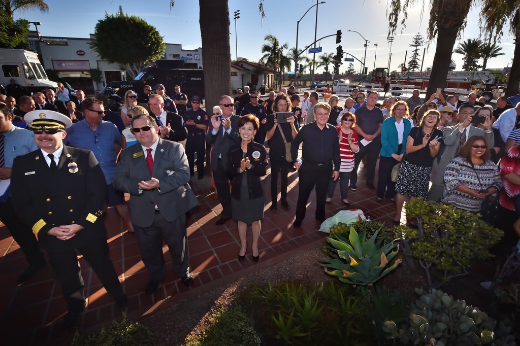 A large crowd of well wishers, including Fullerton/Brea Fire Chief Wolfgang Knabe, left, Council Member Greg Sebourn, Assemblywoman Young Kim and Council Member Doug Chaffee, gather for retiring Fullerton Police Chief Dan Hughes’ Walk of Honor. Photo by Steven Georges/Behind the Badge OC