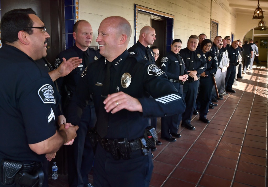 Police Chief Dan Hughes moves down the line of police officers during the Walk of Honor for his retirement ceremony at the Fullerton Police headquarters. Photo by Steven Georges/Behind the Badge OC