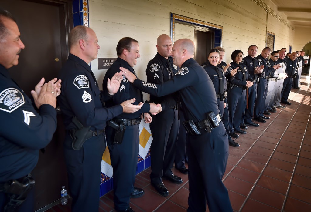 Fullerton Police Chief Dan Hughes moves down the line of police officers during the Walk of Honor for his retirement ceremony at the Fullerton Police headquarters. Photo by Steven Georges/Behind the Badge OC