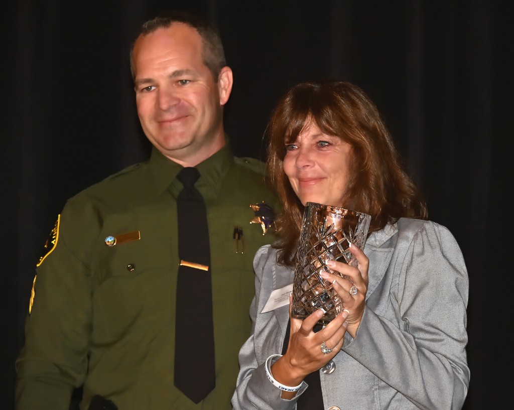 Jodi Barber, child/parent advocate, receives the Community First Compassion Award from Sgt. Brian Gunsolley, left, during the 12th Annual Community First Conference. Photo by Steven Georges/Behind the Badge OC