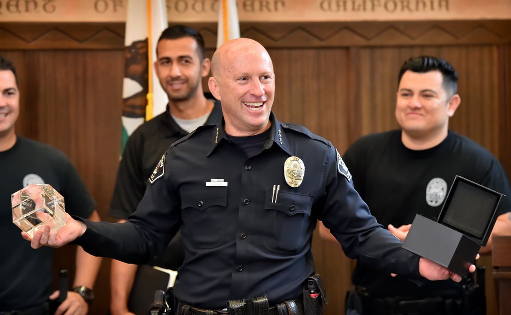 Fullerton PD Chief Dan Hughes smiles as he is surprised by OC GRIP with an award honoring him for his partnership with the organization. Photo by Steven Georges/Behind the Badge OC