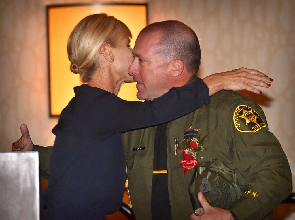 OCSD’s Deputy Thomas Maxwell receives a hug from TIP Volunteer Susie Giovinazzo as Maxwell is honored during the Heroes with Heart awards dinner at the Hilton Anaheim. “On 5/10/16 I was called to a residence in Aliso Viejo to support family members after the death of a loved on. I was incredibly touched when Deputy Maxwell, as he was leaving, gave our client a big hug and said when he got home with his family he would say a prayer for her family. It was the most sincere goodbye I have seen a first responder give one of my clients.” Photo by Steven Georges/Behind the Badge OC