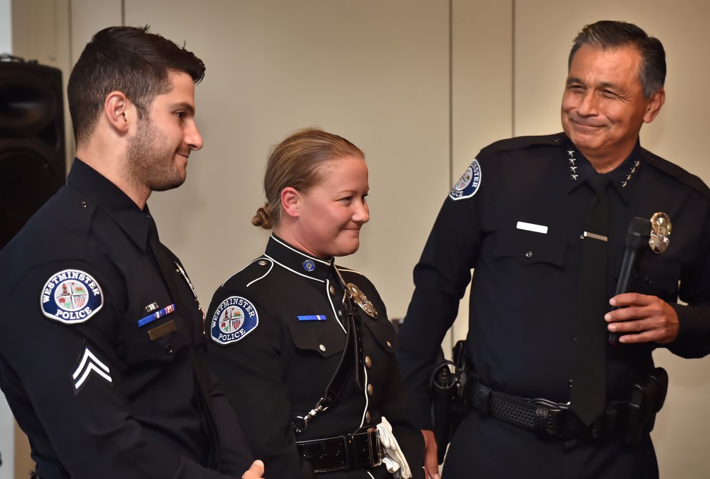 Chief Roy Campos, right, recognize the assignment selections of Corporal Anil Adam, left, and Detective Rachel during a promotions Ceremony in Westminster. Photo by Steven Georges/Behind the Badge OC