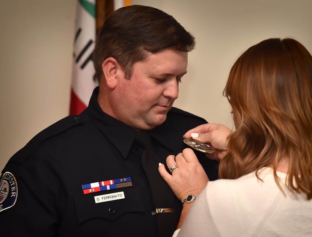 Sgt. Dave Ferronato receives his new sergeant badge from his wife Kristie during a promotions Ceremony in Westminster. Photo by Steven Georges/Behind the Badge OC