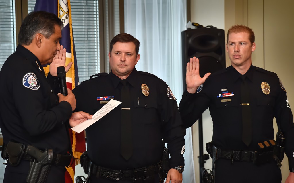 Westminster Interim Chief Roy Campos, left, swears in Sgt. Dave Ferronato and Sgt. Scott Gump, right, during a promotions Ceremony in Westminster. Photo by Steven Georges/Behind the Badge OC