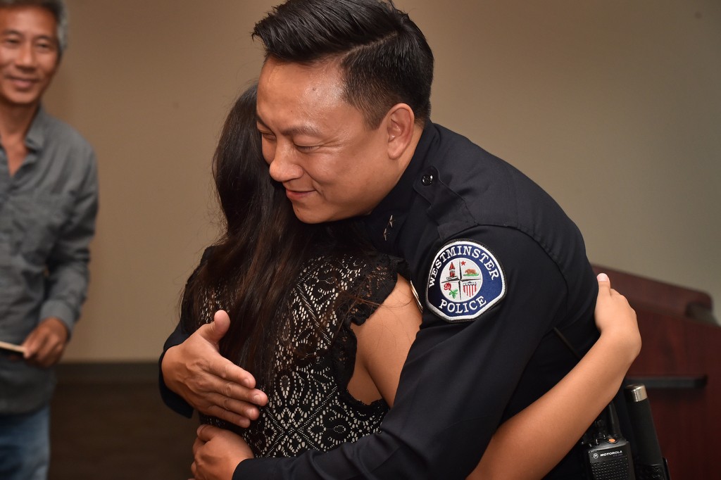 Westminster PD’s new Deputy Chief Timothy Vu gets a hug from his daughter Tyler Vu after receiving his new badge during a promotions ceremony. Photo by Steven Georges/Behind the Badge OC