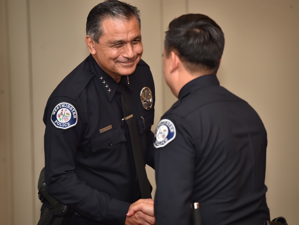Westminster PD Interim Chief Roy Campos, left, congratulates Timothy Vu on his promotion to deputy chief during a promotions ceremony. Photo by Steven Georges/Behind the Badge OC