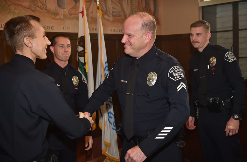Los Angeles PD Officer Nick Wiltz, left, thanks Matt Wilkerson for helping to save his live during an off duty mororcycle accent in August. Behind them are the two other FPD officers who helped, FPD officers Timothy Gibert and Michael Halverson, right. Photo by Steven Georges/Behind the Badge OC