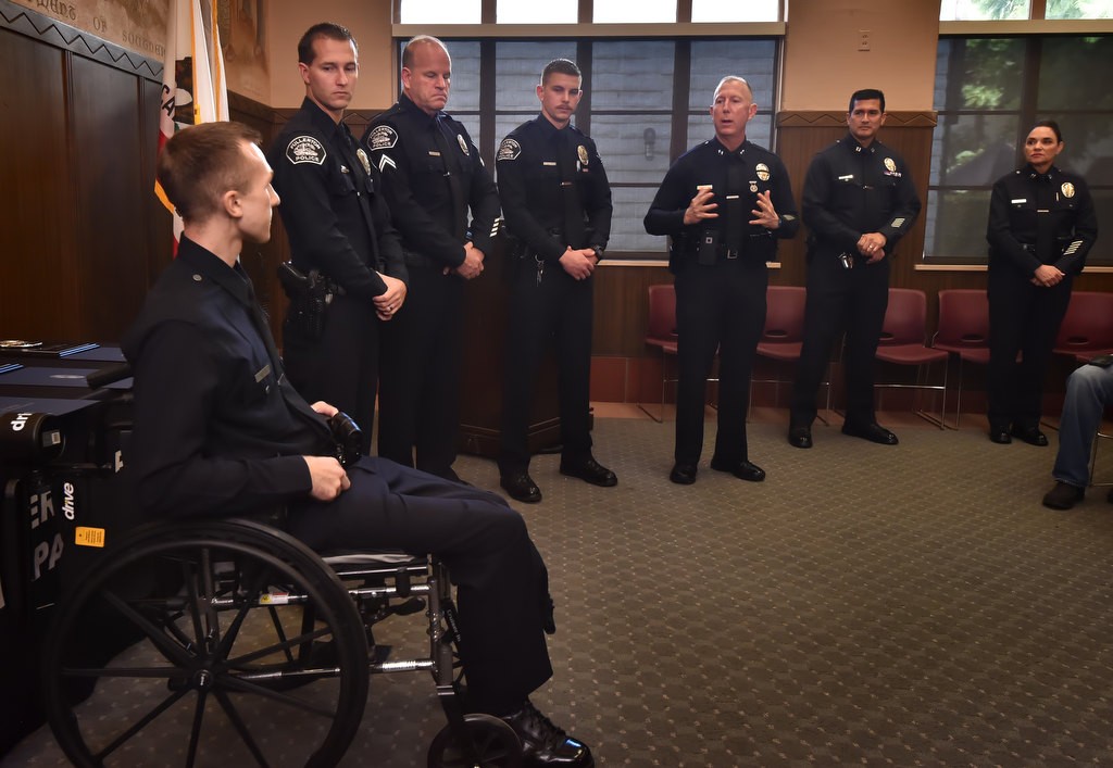Los Angeles Police offers honor three Fullerton PD officers who helped save the life of LAPD Officer Nick Wiltz, left, during an motorcycle accent in August. From left is Officer Wiltz in the wheelchair, FPD Officer Timothy Gibert, FPD Cpl. Matt Wilkerson, FPD Officer Michael Halverson, LAPD Deputy Chief Jon Peters, LAPD Capt. Rolando Solano and Capt. Patrica Sandoval. Photo by Steven Georges/Behind the Badge OC