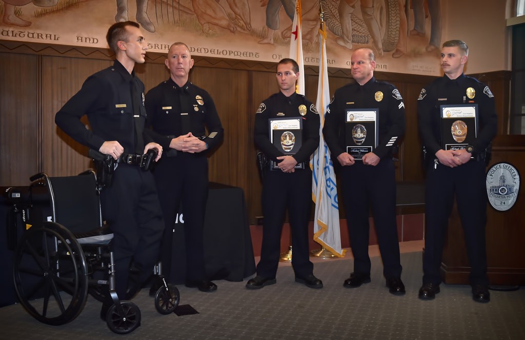 Los Angeles PD Officer Nick Wiltz, left, and Deputy Chief Jon Peters honor Fullerton PD Officer Timothy Gibert, Cpl. Matt Wilkerson and Officer Michael Halverson, right, for their help in saving the life of Officer Wiltz. Photo by Steven Georges/Behind the Badge OC
