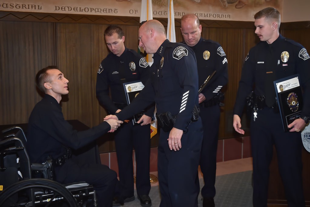 Fullerton Police Chief Dan Hughes welcomes LAPD Officer Nick Wiltz who came to Fullerton PD headquarters to honor Fullerton PD Officer Timothy Gibert, Cpl. Matt Wilkerson and Officer Michael Halverson, right, for helping to save his life after an off duty motorcycle accident that resulted in him loosing his leg. Photo by Steven Georges/Behind the Badge OC