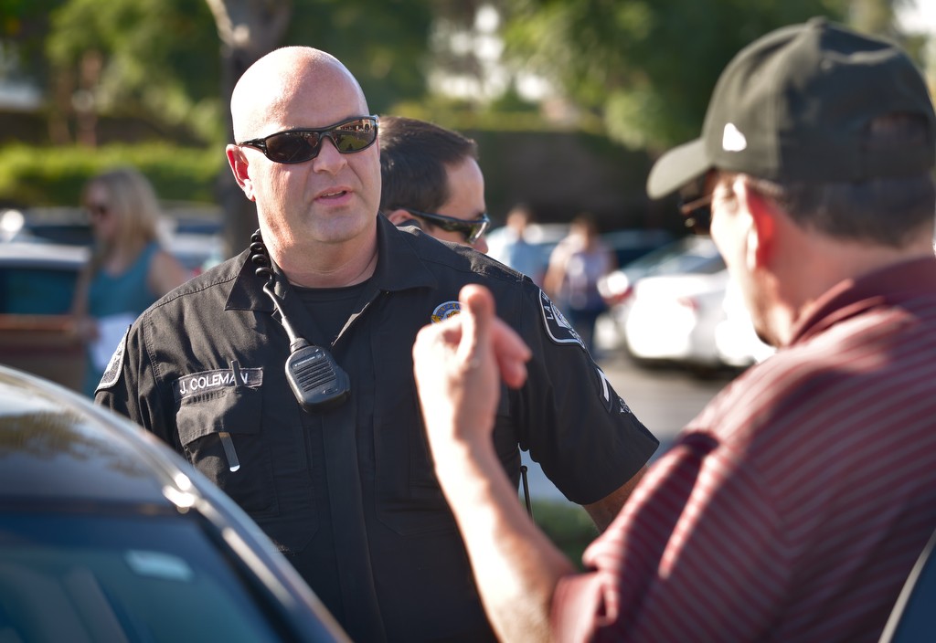 La Habra PD Officer Jason Coleman checks the credentials of Costco shoppers at the handicap parking spaces. Photo by Steven Georges/Behind the Badge OC