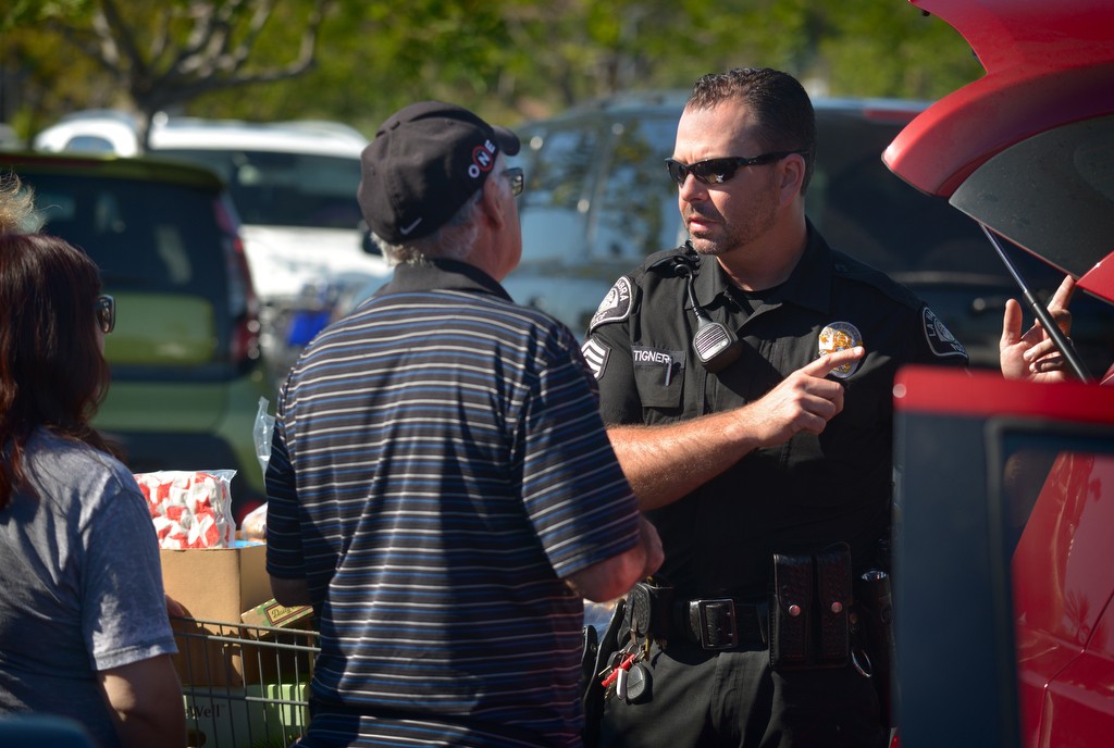 La Habra PD Sgt. Jim Tigner talks to Sam’s Club shoppers who had the proper handicap parking credentials. Photo by Steven Georges/Behind the Badge OC