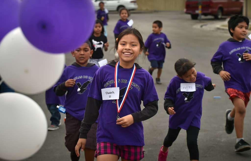 Elizabeth, 10, participates in a fun run during a community gathering at the Palma Vista Ave. neighborhood in Garden Grove. Photo by Steven Georges/Behind the Badge OC