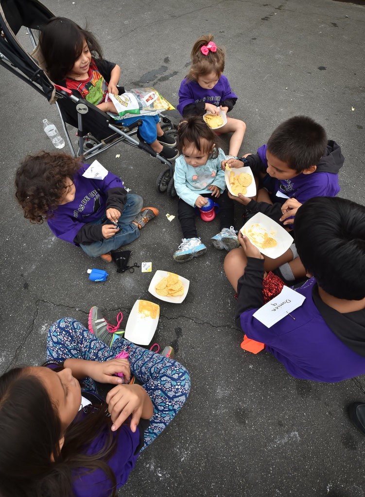 Neighborhood kids gather for a snack during a community gathering at the Palma Vista Ave. neighborhood in Garden Grove. Photo by Steven Georges/Behind the Badge OC