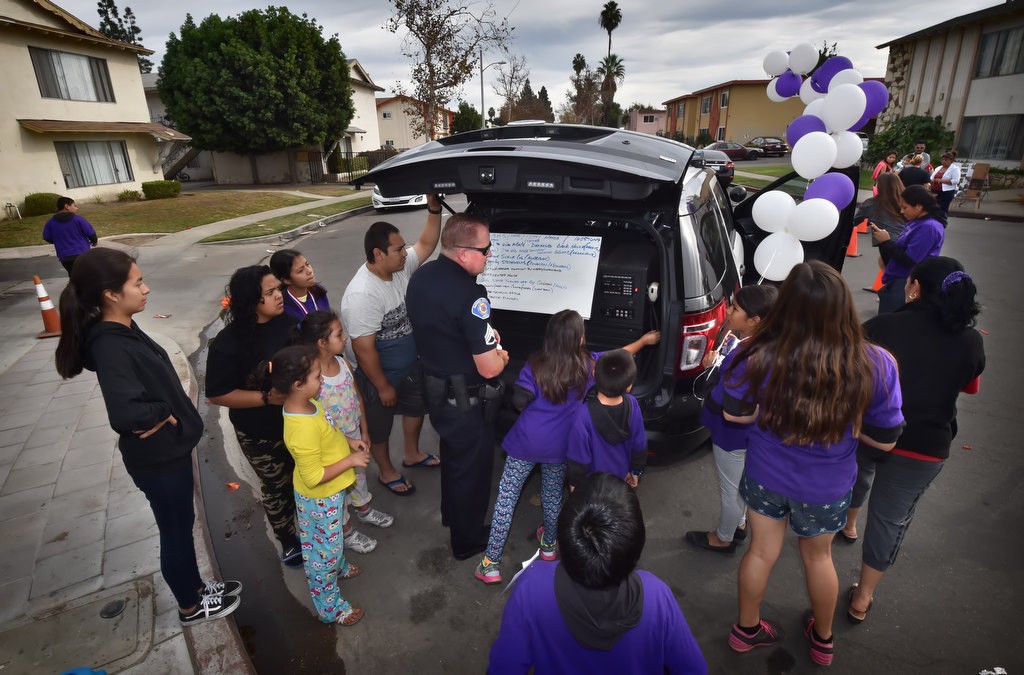 Garden Grove PD Sgt. Jon Wainwright gives kids from the the Palma Vista Ave. neighborhood a tour of a police sergeant’s SUV. Photo by Steven Georges/Behind the Badge OC